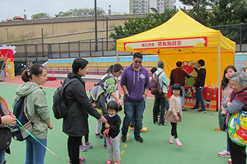 Members of the public queueing to play a game on adoption