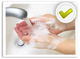 An adult washing hands with water and soap